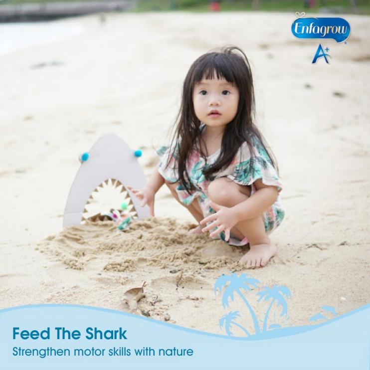 toddler playing in sand