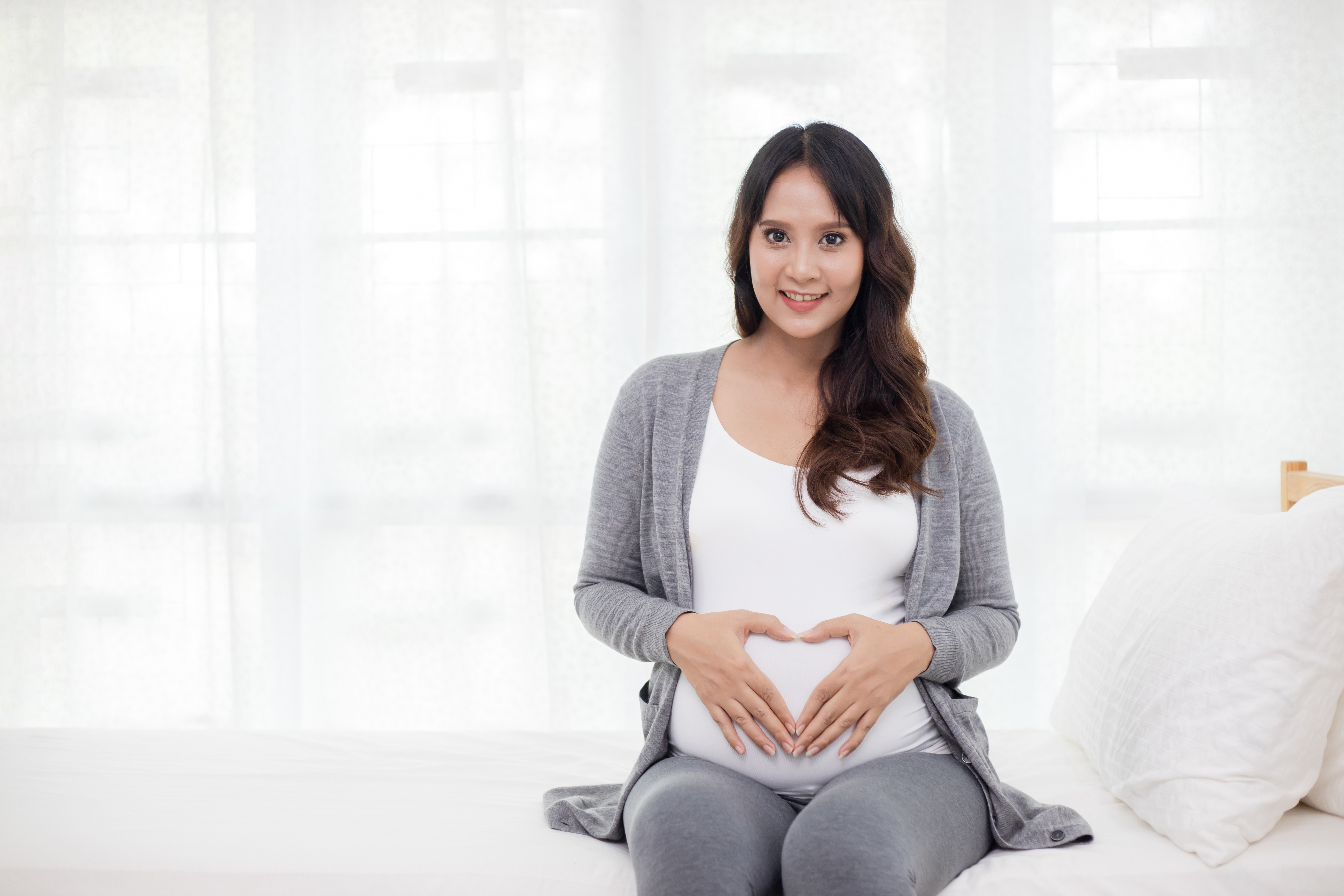 8 weeks pregnant lady holding her belly