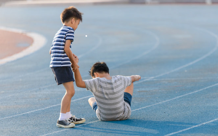 boy helping another child